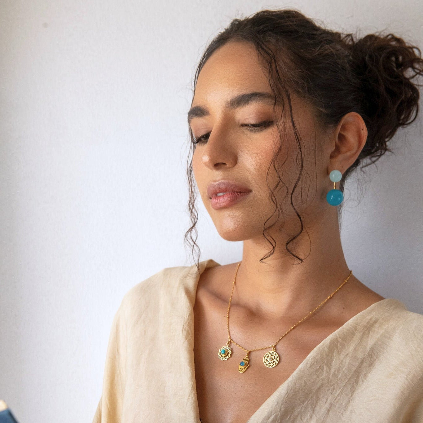 Woman wearing jewelry with a plain background